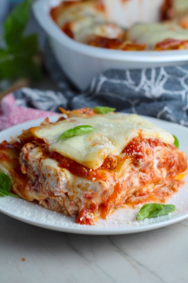 Chicken Lasagna on a plate with fresh basil. from the dish. This Italian Sausage Lasagne Recipe is the stuff that dreams are made of.  Layers of pasta, creamy ricotta, salty chewy mozzarella, salty and hearty Italian Sausage, and sweet and tangy tomato sauce.