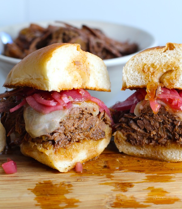 Pulled Beef Brisket Sandwich made in the Slow Cooker is smokey, savory, tender, moist, and full of flavor. In a delicious sauce, it goes great on a sandwich, over polenta, on rice, or potatoes. #slowcooker #crockpot #brisket #beefbrisket #pulledbeef #pulledpork