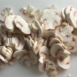 Sliced mushrooms for Chicken Stroganoff with mushrooms, and spinach. It has a thick, creamy, savory mushroom sauce with a touch of tangy sour cream. #chickendinners #chickenrecipes #familydinners #dinnerideas