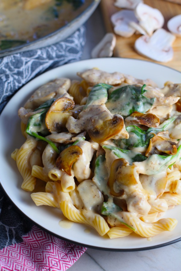 This Chicken Stroganoff Recipe with Spinach over pasta has a thick, creamy, savory, and earthy mushroom sauce with a touch of tangy brightness from the sour cream.  Then you have meaty and hearty chicken strips and spinach. #stroganoff #chickendinners #chickenrecipes #familydinners #dinnerideas