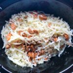 Raw hash browns and chorizo in Slow Cooker for Egg Casserole with Chorizo, Potatoes and both cheddar and manchego cheeses. IT COOKS WHILE YOU SLEEP! #eggs #eggcasseroles #eggrecipes #breakfastideas #holidayrecipe
