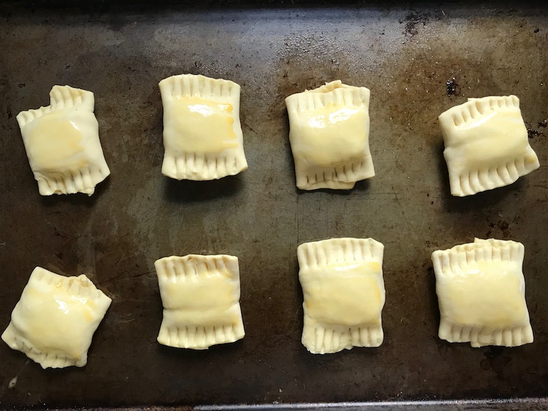 Uncooked Mini Beef Wellington Bites on pan. They are flaky and buttery Puff Pastry is filled with a creamy mushroom and parmesan filling and tender beef filet.  #appetizers #partyfood