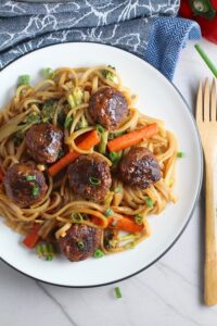 Teriyaki Meatballs with Veggie Stir Fry, and rice noodles on a plate.  #asianmeatballs #teriyaki #noodles #familydinner #easydinners #dinnerideas