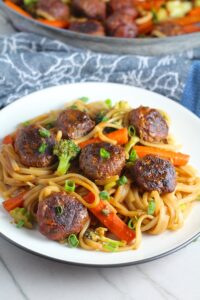 Teriyaki Meatballs with Veggie Stir Fry, and rice noodles on a plate.  #asianmeatballs #teriyaki #noodles #familydinner #easydinners #dinnerideas