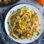 Orange Brown Butter Shrimp Pasta Recipe on a plate. It has a silky sauce that's buttery, nutty, and slightly sweet! #shrimprecipes #shrimppasta #easydinners #dinnerideas 