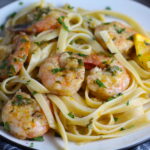 Orange Brown Butter Shrimp Pasta Recipe on a plate. It has a silky sauce that's buttery, nutty, and slightly sweet! #shrimprecipes #shrimppasta #easydinners #dinnerideas 