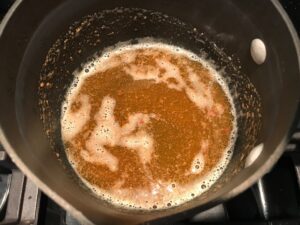 Browned butter in pot for the Orange Brown Butter Shrimp Pasta Recipe.  It has a silky sauce that's buttery, nutty, and slightly sweet! #shrimprecipes #shrimppasta #easydinners #dinnerideas 