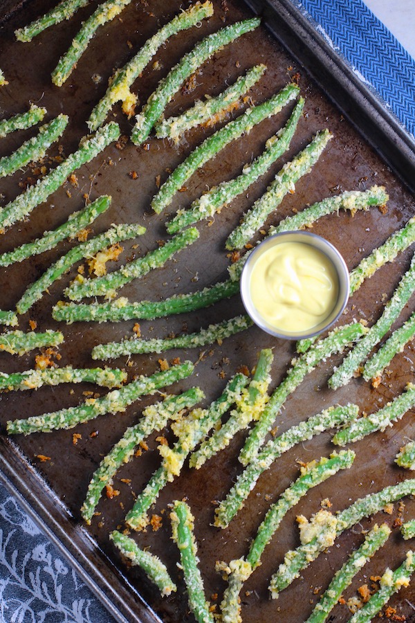 Crispy, crunchy, salty, and addictive!  These are my healthy Crispy Parmesan Green Bean Fries!  Such a great way to transform beans and add a new vegetable into dinner rotation. #vegetablerecipes