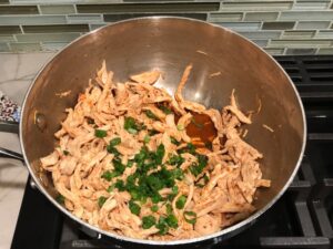 Shredded Chicken mixture for Chicken Taquitos. Corn tortillas are filled with smoky taco seasoned shredded chicken, and creamy cheddar cheese.  #dinnerideas #familydinner #chickenrecipes #chickendinner #tacos #taquitos