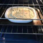 Cottage Pie recipe cooking in oven. It has Spanish Chorizo and ground beef cooked in a rich and savory gravy with veggies and herbs.  Creamy mashed potatoes sit on top with manchego, parmesan, and garlic. #dinnerideas #cottagepie #shepherdspie