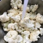 Cauliflower florets in pot for Cauliflower Gnocchi, which are soft, silky, buttery, and melt-in-your-mouth! Made with cauliflower, they're a healthier version to traditional gnocchi! Add my simple Garlic Butter Sauce or Tomato Sauce and they are heaven.  #dinnerideas #gnocchi #cauliflower