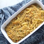 Bacon Mac and Cheese in baking dish. It has a creamy and cheesy sauce with a touch of smokiness from the bacon, coats each piece of pasta.  On top, crispy crunchy, indulgent bacon fat cracker crumbs!