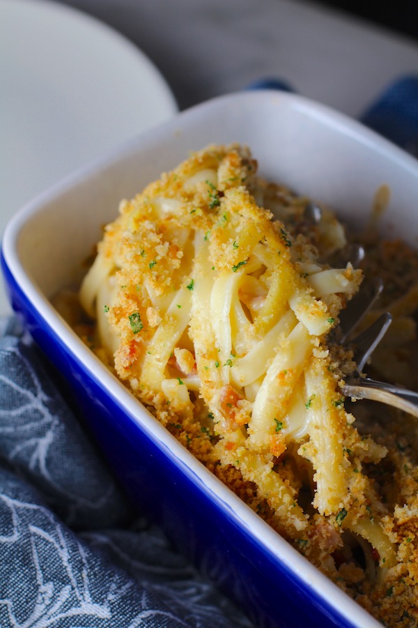 Manchego Mac and Cheese with Bacon scooped up. It has a creamy and cheesy sauce with a touch of smokiness from the bacon, coats each piece of pasta.  On top, crispy crunchy, indulgent bacon fat cracker crumbs!