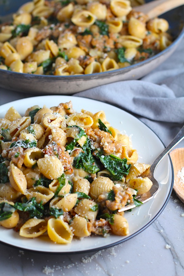 Shell Pasta with Italian Sausage and Kale on a plate. It's loaded with a salty homemade Chicken Italian Sausage flavored with garlic and fennel in a parmesan, garlic and kale sauce. 