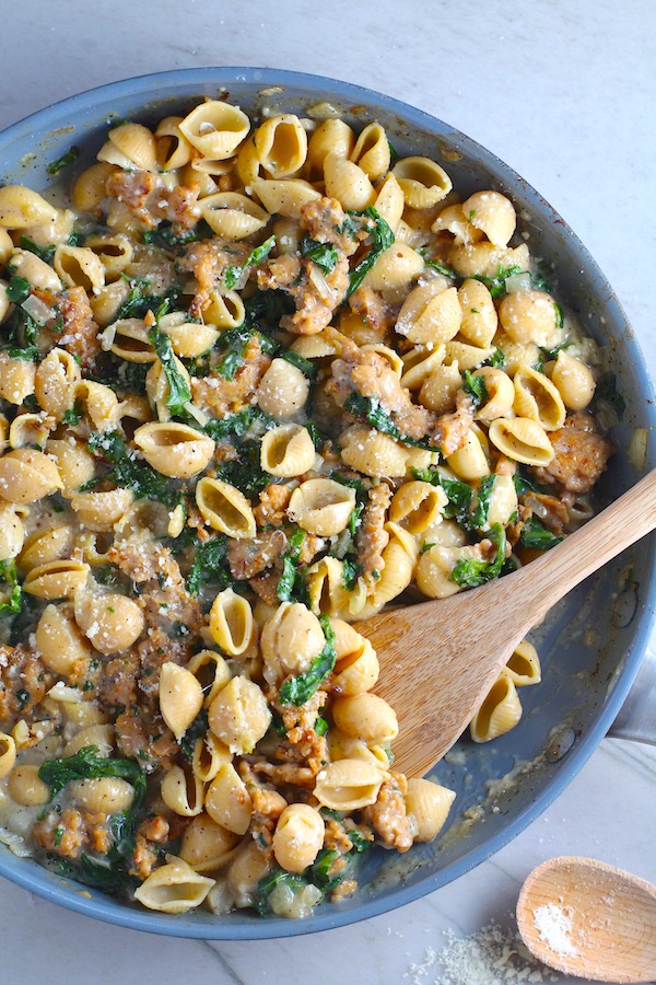 Shell Pasta with Italian Sausage and Kale in a pan. It's loaded with a salty homemade Chicken Italian Sausage flavored with garlic and fennel in a parmesan, garlic and kale sauce. 