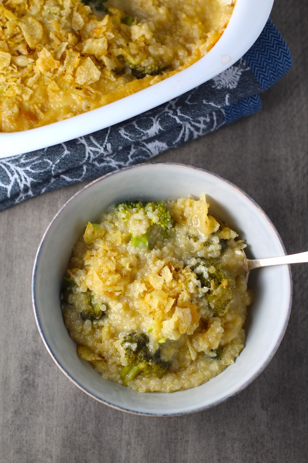 Broccoli Cheese Quinoa Bake in a bowl with potato chips on top. It's a comfy cozy casserole that's perfect to make ahead for a simple weeknight side or main dish.