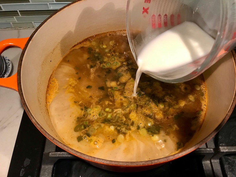 Adding slurry to soup for Creamy Chicken Enchilada Soup. It's creamy, hearty, slightly spicy with green chiles and smokey seasonings that bring so much depth.  Corn tortilla strips act like the noodles in this soup!