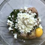 Ground Chicken Greek Meatball ingredients in a bowl. These meatballs have garlic, feta, parsley, and oregano