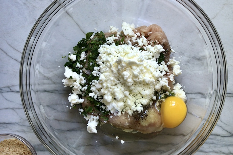 Ground Chicken Greek Meatball ingredients in a bowl. These meatballs have garlic, feta, parsley, and oregano