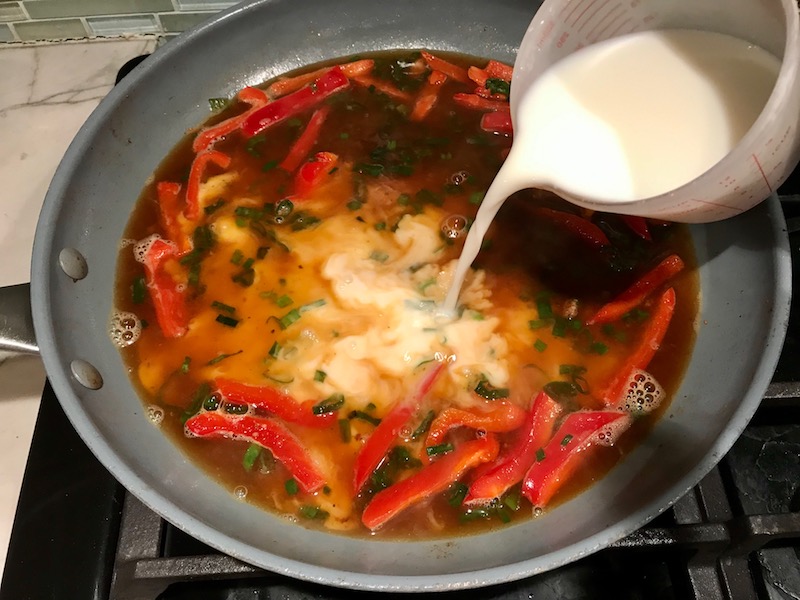 Adding slurry to pan for Tarragon Mustard Chicken with Red Peppers. It's creamy, tangy, savory, and so addictive.