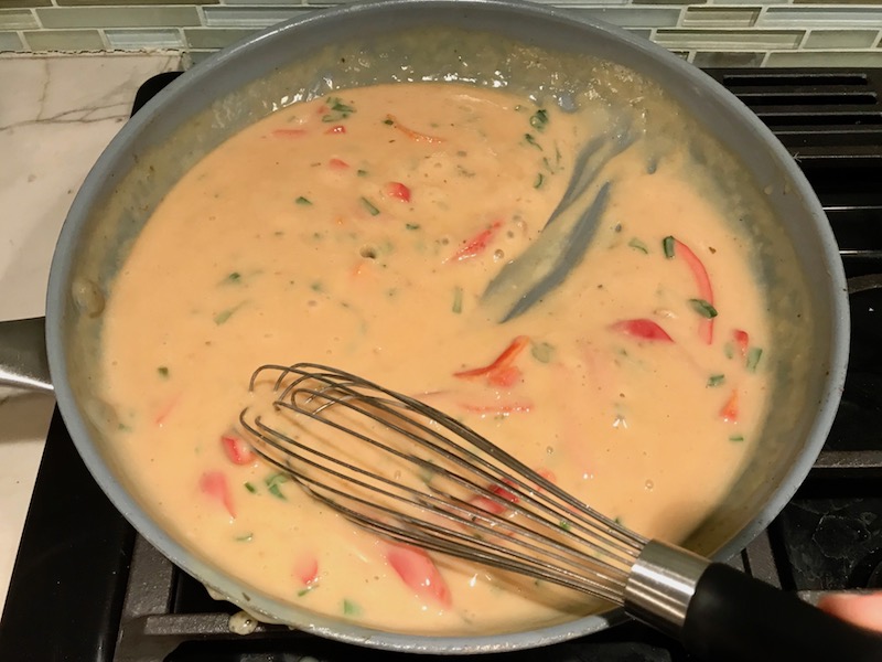 Thickened sauce in pan for Tarragon Mustard Chicken with Red Peppers. It's creamy, tangy, savory, and so addictive.