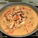 Add chicken to sauce in pan for Tarragon Mustard Chicken with Red Peppers. It's creamy, tangy, savory, and so addictive.