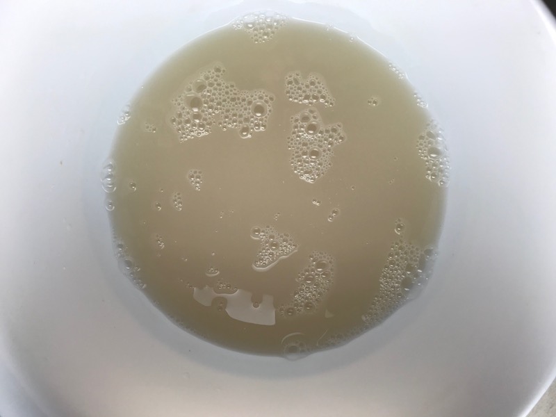 Yeast, sugar, and water in bowl for a BBQ Chicken Pizza Recipe
