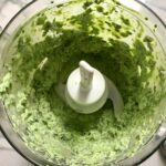 Basil, chives, spinach, and sour cream blended in food processor for Green Rice Recipe. It takes white rice from plain to amazing with just 5 ingredients. Filled with herbs and spinach, it has the perfect herby flavor.