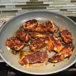 Blackened chicken in pan for Creamy Corn and Blackened Chicken skillet dinner