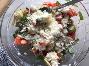 Ingredients in bowl for Chicken Artichoke Bake with Tomatoes and Goat Cheese.  It's a creamy, tangy, sweet, savory, mouth watering easy dinner that you can prep ahead!