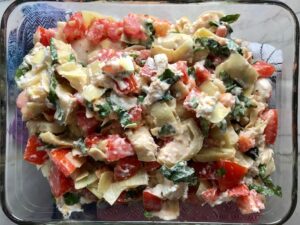 Topping added on top of chicken for Chicken Artichoke Bake with Tomatoes and Goat Cheese.  It's a creamy, tangy, sweet, savory, mouth watering easy dinner that you can prep ahead!