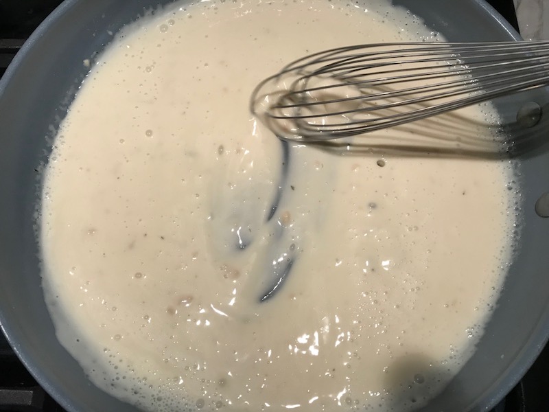 Whisking sauce in pan for Light and Easy Fettuccine Alfredo with Prosciutto