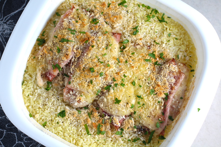 Chicken Cordon Bleu Rice Bake in casserole dish.  On the bottom you get flavorful rice topped with chicken, salty ham, nutty and melty swiss cheese, and a crunchy breadcrumb topping!