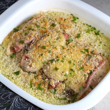 Chicken Cordon Bleu Rice Bake in casserole dish.  On the bottom you get flavorful rice topped with chicken, salty ham, nutty and melty swiss cheese, and a crunchy breadcrumb topping!