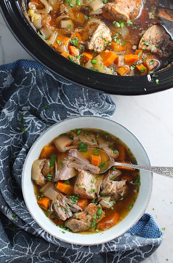 Paprika Pork Stew Recipe in a bowl with carrots, onion, parsley. It's an easy family dinner. 
