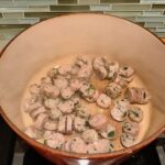 Sausage slices in pot for Creamy Chicken Sausage and Tortellini Soup. It's silky and creamy with onions, garlic, Chicken sausage, and zucchini bring so much flavor and texture.  The tortellini give that delicious salty, creamy, hearty bite! 