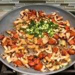 Chorizo, mushrooms, and scallions in frying pan for Creamy Green Beans and Mushrooms with Chorizo in a serving bowl are a creamy and savory side dish.