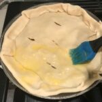 Pie crust on skillet for Empanada Beef Pie Recipe. It has a perfect flaky, buttery pastry on the outside with a savory, smokey, salty ground beef filling.  The best part is that everything cooks in one skillet!