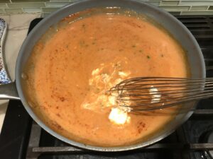 Whisk mixing mayonnaise into sauce in a frying pan for Quick Cooking Creamy Chicken Paprika. It's creamy, smokey, rich, and hearty. This is an easy weeknight family dinner!
