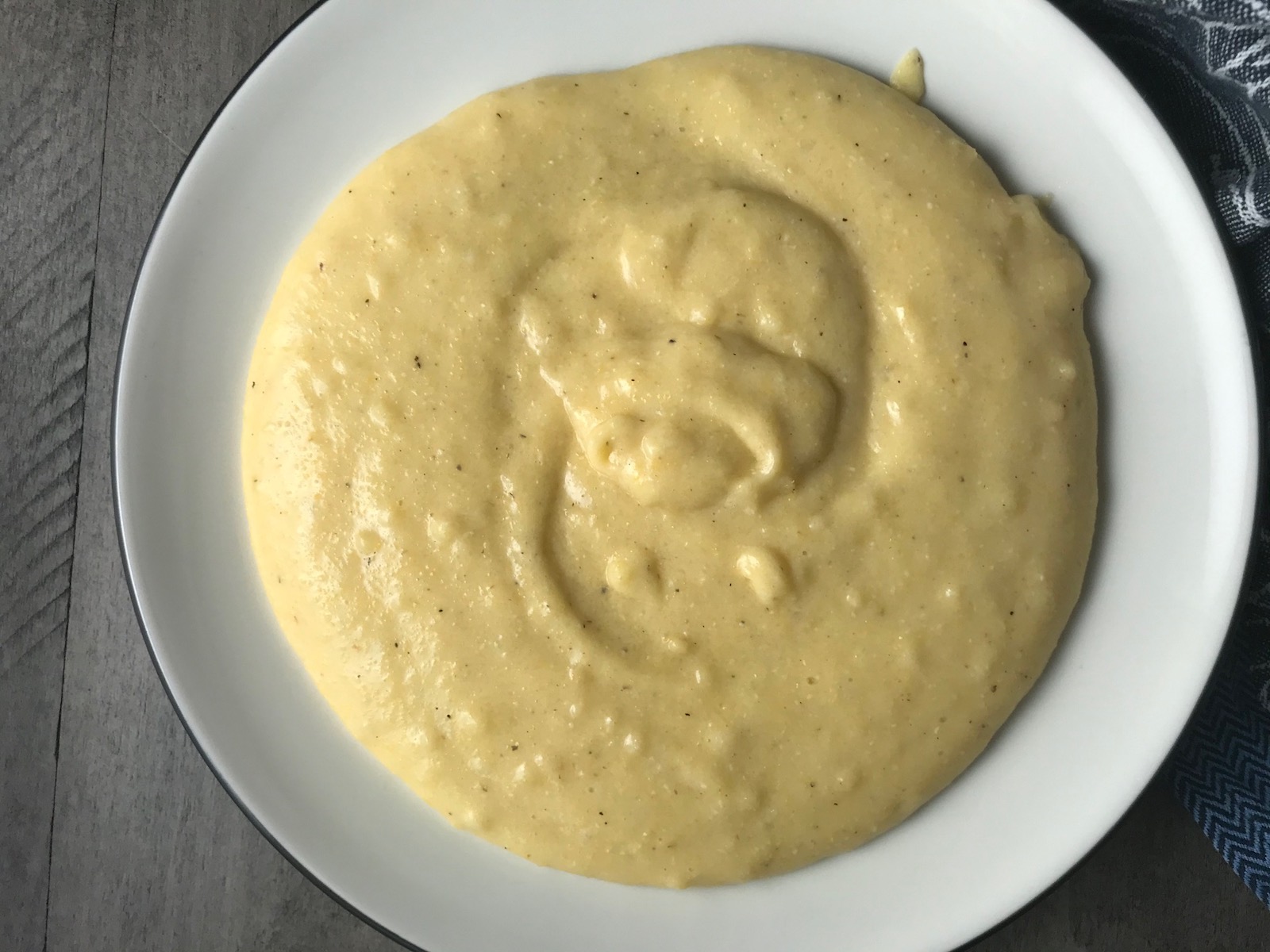 Creamy cheesy grits on a plate for Shrimp and Grits recipe. 