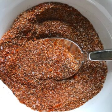 Cajun Seasoning in a bowl with spoon. It's smokey, spicy, salty, peppery, and adds fast flare to so many different foods.