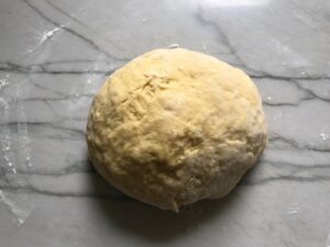 dough ball on floured counter for Easy Homemade Pasta recipe.