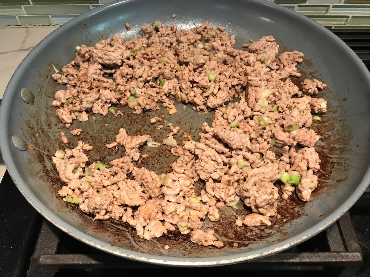 Cooked ground chicken in a pan for Dan Dan Noodle Recipe with Ground Chicken.