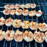 Shrimp skewers grilling on outdoor grill for Grilled Shrimp Tacos