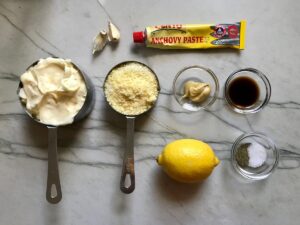 Ingredients on counter for Caesar dressing for Kale Caesar Salad with Baked Crispy Lemon Chicken strips