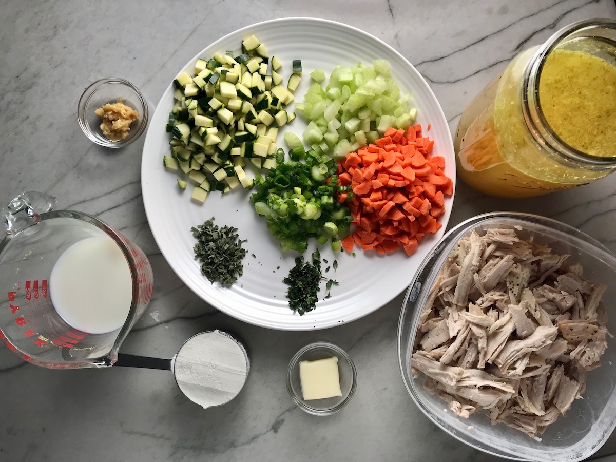 All ingredients on counter for Puff Pastry Turkey Pot Pie.  It's an easy dinner recipe to use leftover turkey from the holidays and ingredients you can have on hand! The vegetables and sauce come together so easily and store-bought puff pastry is a time saver.