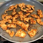 MExican Marinated Chicken pieces cooking in a skillet.
