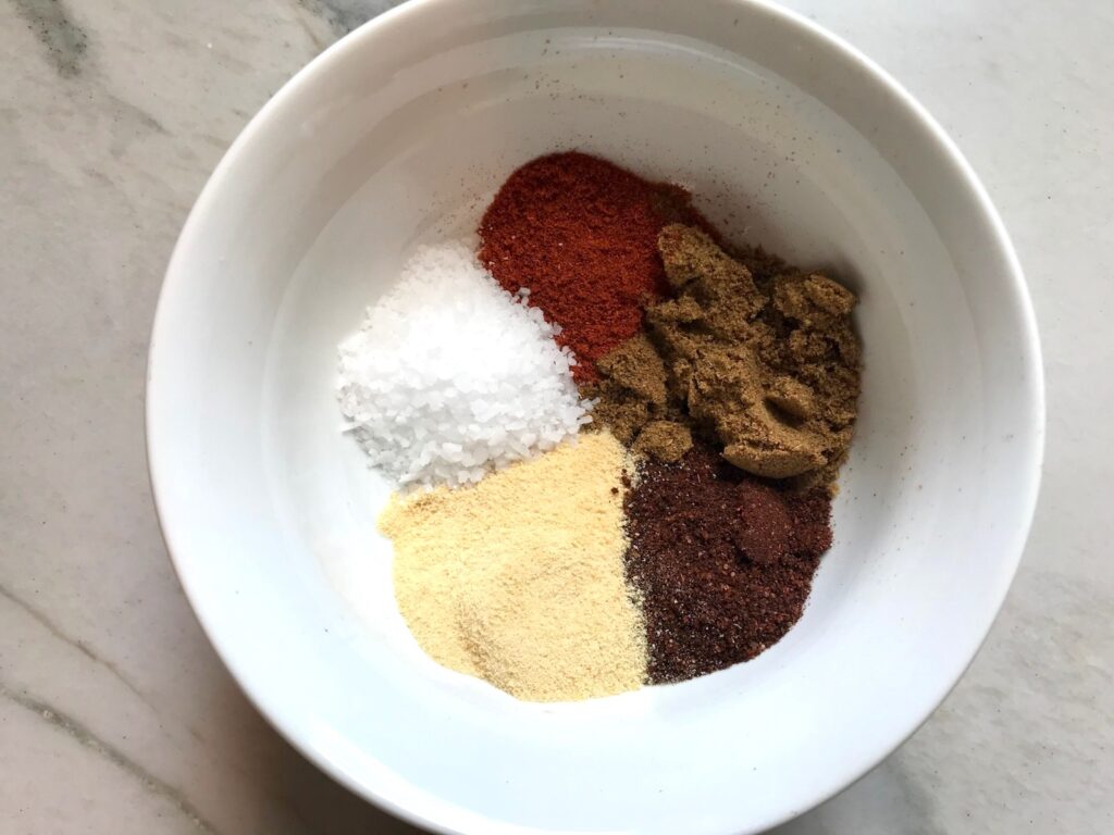 Seasonings in bowl (clockwise) smoked paprika, cumin, chili powder, garlic powder, salt for Taco Meat Recipe.