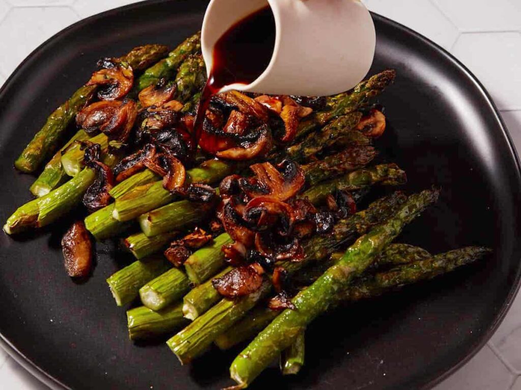 What to serve with pasta bake? This Balsamic Roasted Asparagus and Mushrooms recipe from Butter and Baggage!