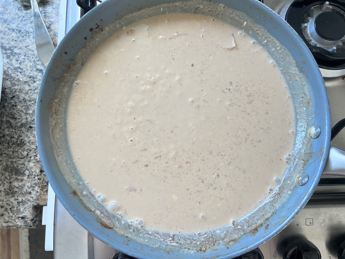 Cream cheese sauce in skillet for Philly Cheesesteak casserole recipe with Steak.